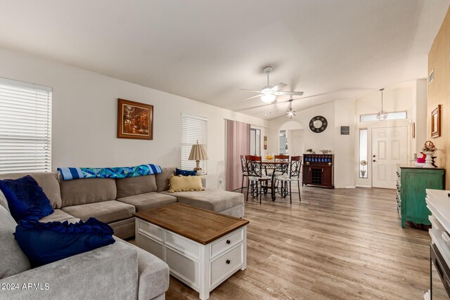 living room with lofted ceiling, ceiling fan, and light hardwood / wood-style floors