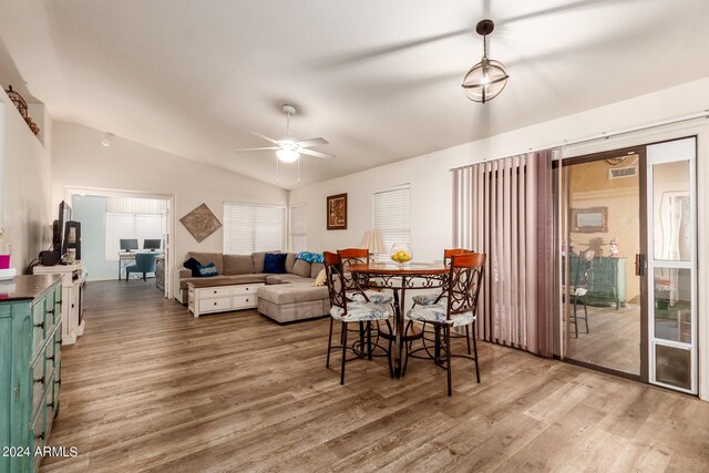 dining area featuring lofted ceiling, ceiling fan, and hardwood / wood-style flooring