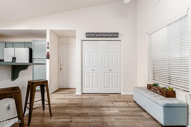 foyer entrance with lofted ceiling and light hardwood / wood-style flooring