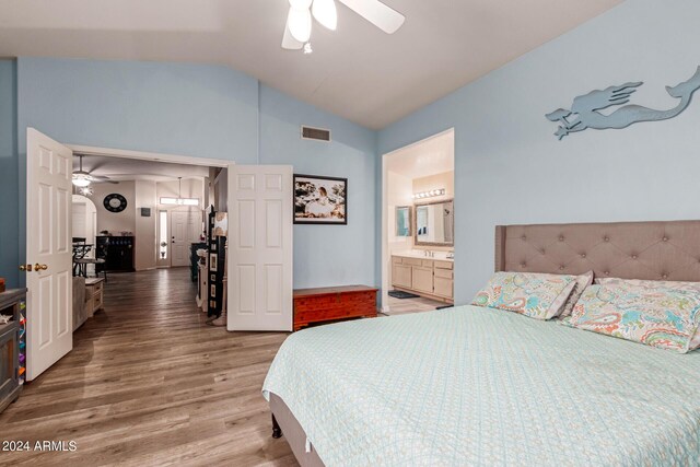 bedroom featuring ensuite bathroom, ceiling fan, vaulted ceiling, and hardwood / wood-style flooring