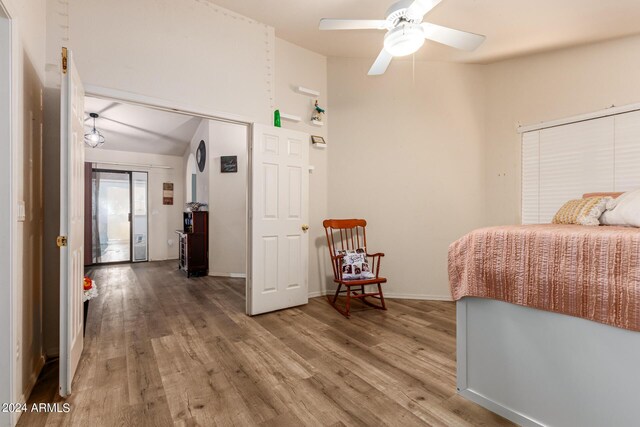 bedroom featuring wood-type flooring, ceiling fan, and a closet