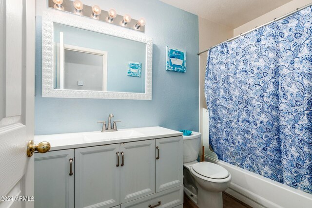 full bathroom featuring vanity, toilet, and shower / bathtub combination with curtain