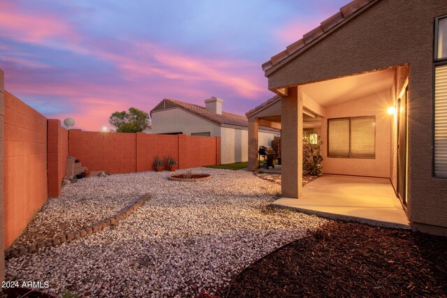 yard at dusk with a patio