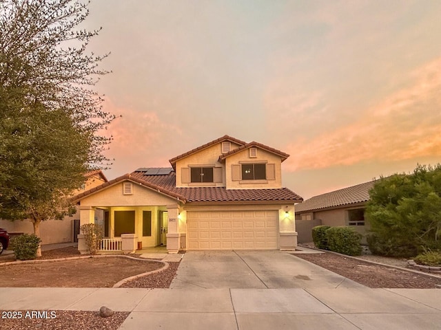 view of front of property featuring a garage and solar panels