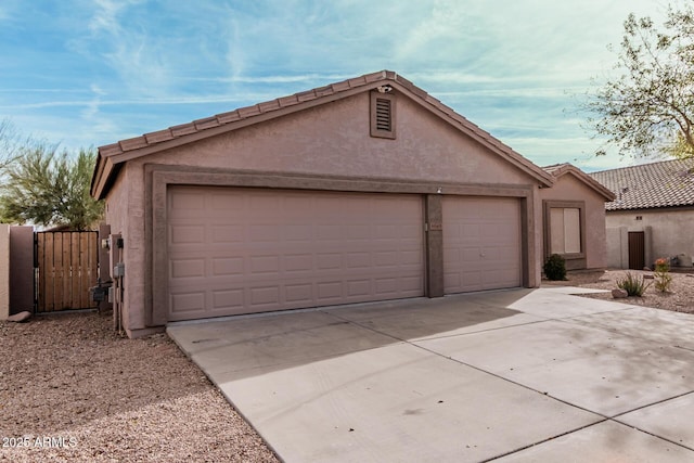 garage featuring concrete driveway