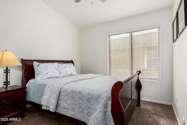 bedroom featuring multiple windows, baseboards, dark colored carpet, and a ceiling fan