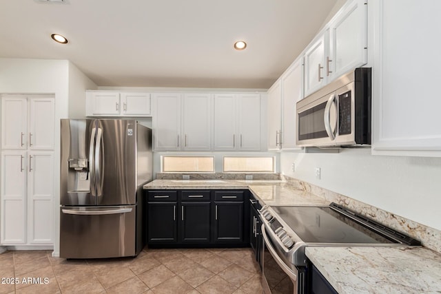 kitchen with stainless steel appliances, recessed lighting, white cabinets, and light tile patterned floors