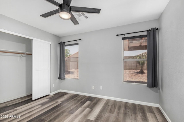 1180 W Rosal Ave, Apache Junction, AZ 85120 - unfurnished bedroom with dark wood finished floors, a closet, baseboards, and a ceiling fan
