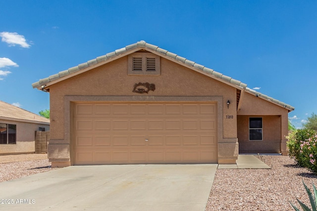 1180 W Rosal Ave, Apache Junction, AZ 85120 - view of front of home featuring concrete driveway, a garage, stucco siding, and a tile roof