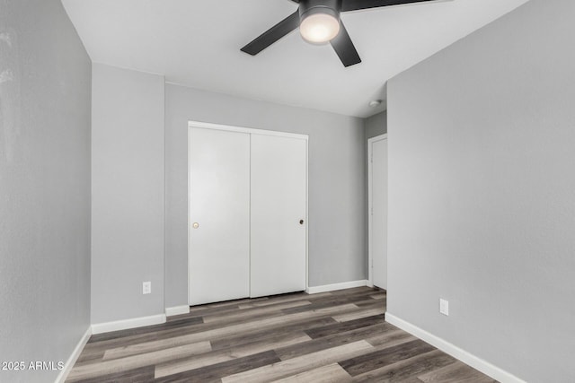 1180 W Rosal Ave, Apache Junction, AZ 85120 - unfurnished bedroom featuring wood finished floors, a closet, baseboards, and a ceiling fan
