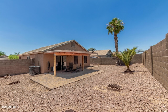 1180 W Rosal Ave, Apache Junction, AZ 85120 - rear view of house with central air condition unit, stucco siding, a fenced backyard, and a patio area