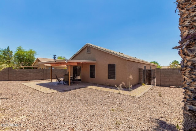 1180 W Rosal Ave, Apache Junction, AZ 85120 - rear view of house with stucco siding, a fenced backyard, and a patio area