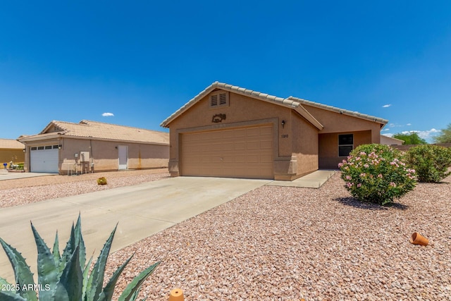 1180 W Rosal Ave, Apache Junction, AZ 85120 - single story home featuring a garage, stucco siding, concrete driveway, and a tile roof