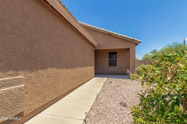 1180 W Rosal Ave, Apache Junction, AZ 85120 - view of exterior entry featuring stucco siding and a patio