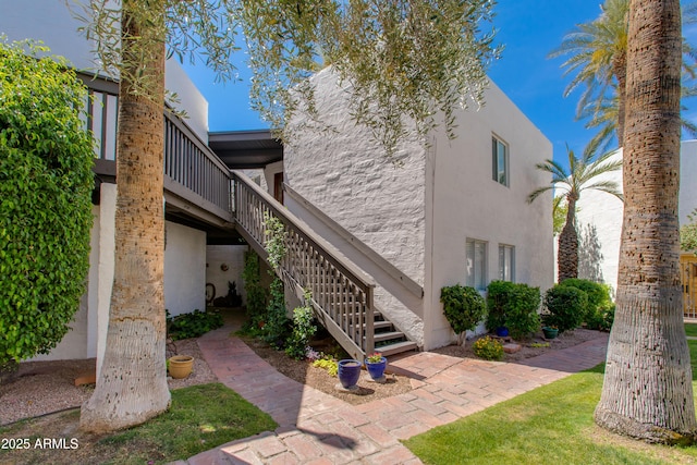 6840 E 2nd St Unit 23, Scottsdale, AZ 85251 - view of side of property with stairs and stucco siding
