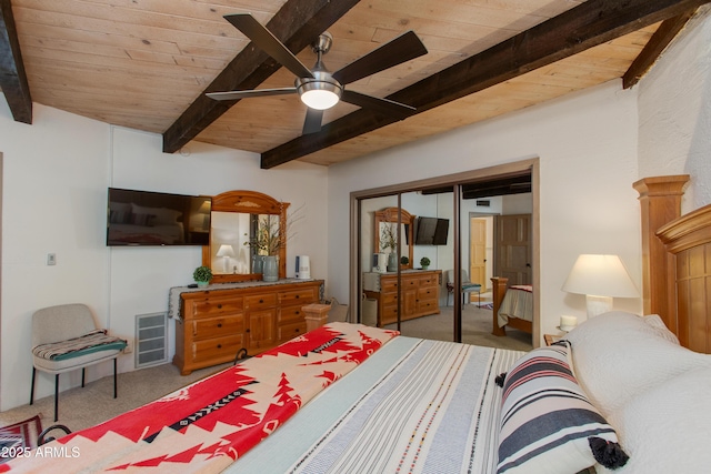 6840 E 2nd St Unit 23, Scottsdale, AZ 85251 - bedroom with carpet flooring, wood ceiling with exposed beams, a closet, and a ceiling fan