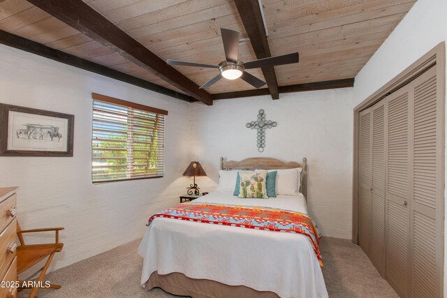 6840 E 2nd St Unit 23, Scottsdale, AZ 85251 - carpeted bedroom featuring wood ceiling with exposed beams, a closet, and ceiling fan