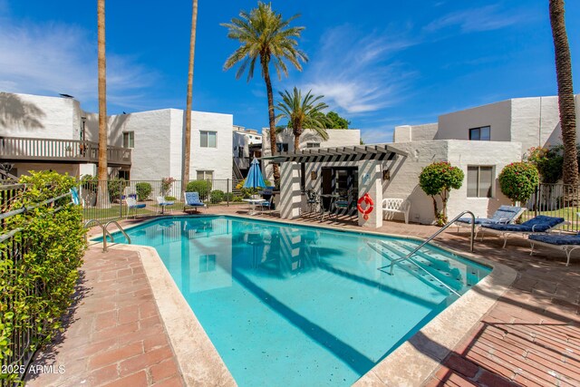 6840 E 2nd St Unit 23, Scottsdale, AZ 85251 - view of swimming pool featuring a pergola, a patio, and a residential view