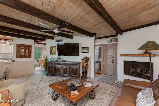 6840 E 2nd St Unit 23, Scottsdale, AZ 85251 - living area with wood ceiling with exposed beams, light colored carpet, a ceiling fan, and a wainscoted wall