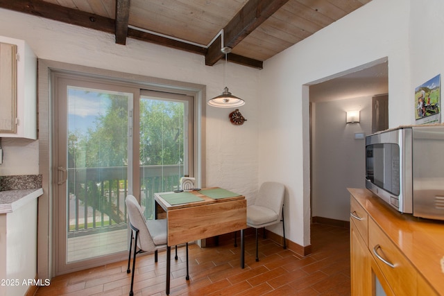 6840 E 2nd St Unit 23, Scottsdale, AZ 85251 - dining room featuring baseboards, wood ceiling with exposed beams, and wood finished floors