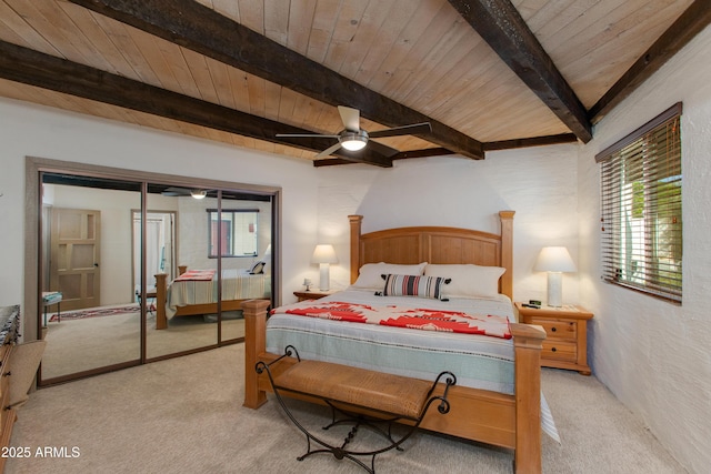 6840 E 2nd St Unit 23, Scottsdale, AZ 85251 - bedroom with light colored carpet, wood ceiling with exposed beams, ceiling fan, and a textured wall
