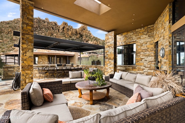 view of terrace featuring an outdoor living space with a fireplace