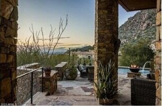 view of patio terrace at dusk