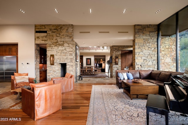 living room with wood-type flooring and a wood stove