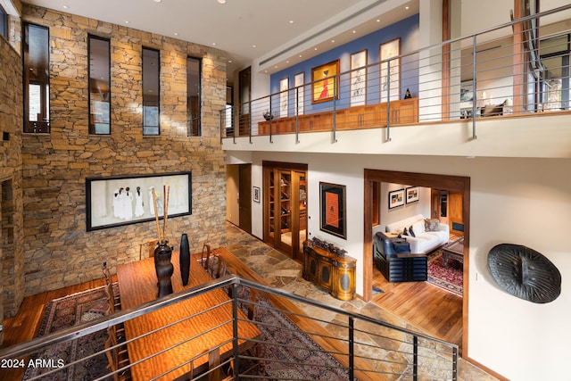 interior space featuring wood-type flooring and a towering ceiling