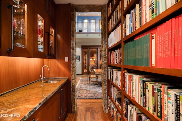 hallway with sink and wood-type flooring