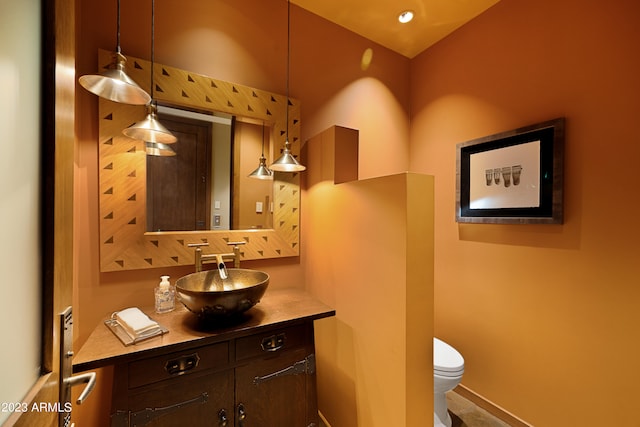 bathroom featuring toilet and vanity