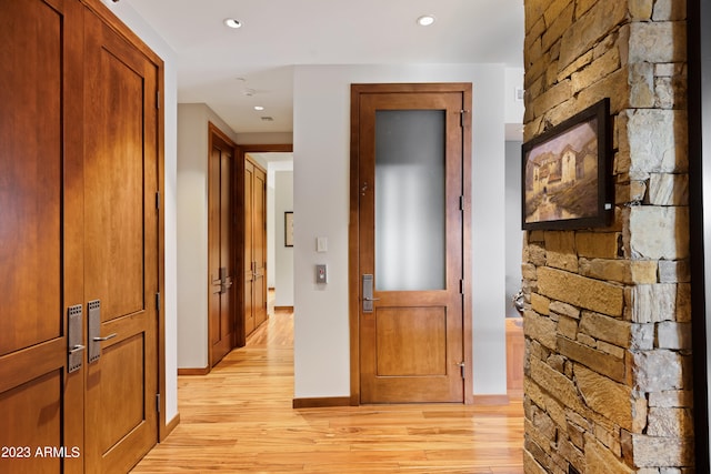 corridor featuring light hardwood / wood-style floors