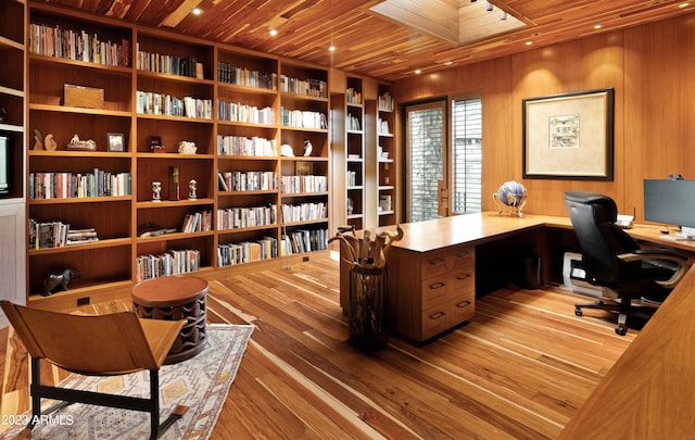 office area with wooden ceiling, light wood-type flooring, and wooden walls