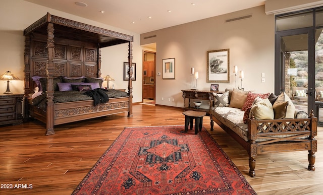 bedroom featuring hardwood / wood-style flooring and access to exterior