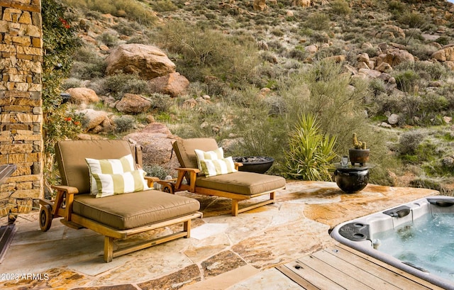 view of patio / terrace with an outdoor hot tub