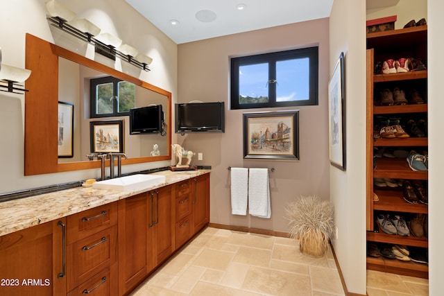 bathroom featuring a healthy amount of sunlight, vanity, and tile floors