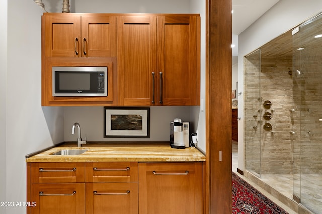 kitchen with sink and light stone counters