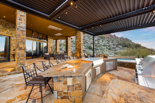 view of patio with exterior kitchen and area for grilling