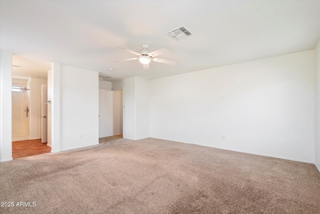 carpeted spare room featuring ceiling fan