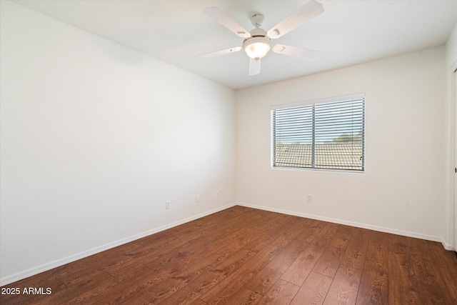 empty room featuring ceiling fan and dark hardwood / wood-style flooring