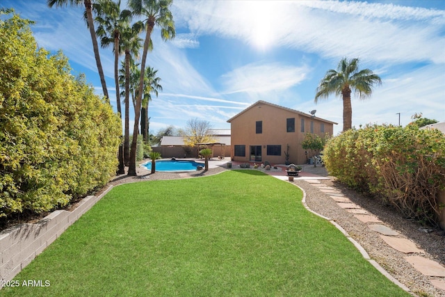 view of yard featuring a fire pit and a fenced in pool