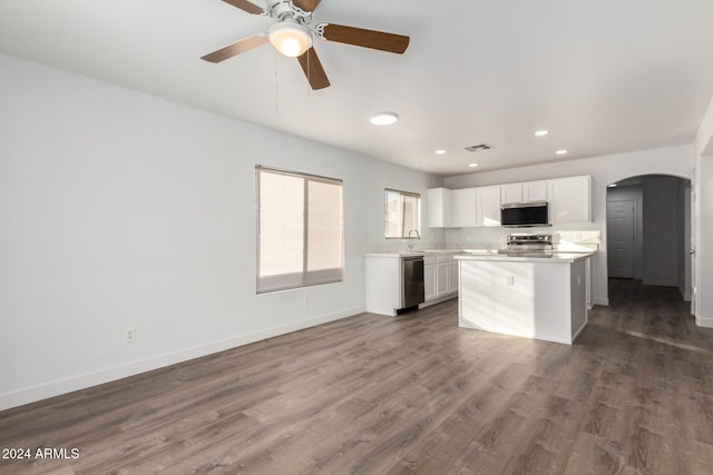 kitchen with dark hardwood / wood-style floors, a kitchen island, white cabinetry, and stainless steel appliances