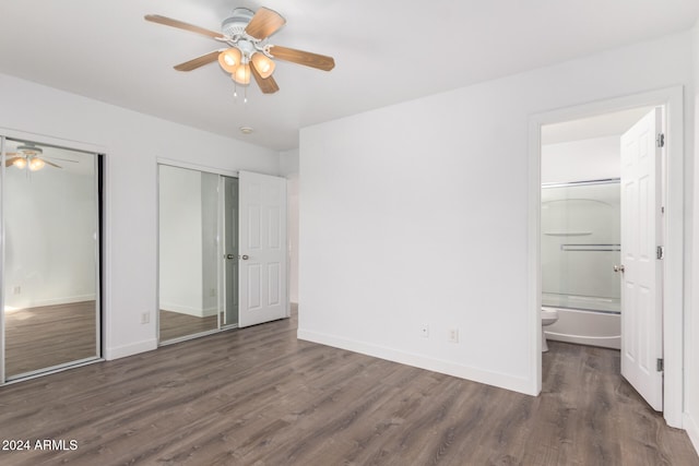 unfurnished bedroom featuring ensuite bathroom, dark hardwood / wood-style floors, and ceiling fan