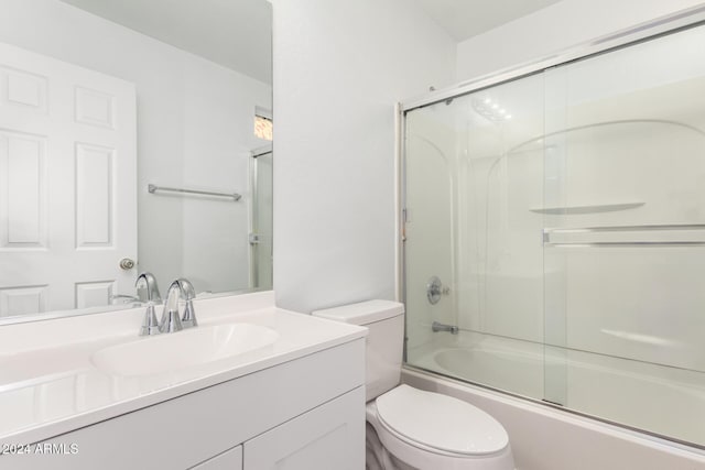 full bathroom with shower / bath combination with glass door, vanity, and toilet