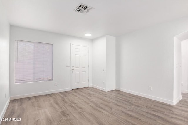 spare room featuring light hardwood / wood-style flooring