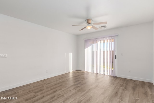 spare room featuring light hardwood / wood-style floors and ceiling fan