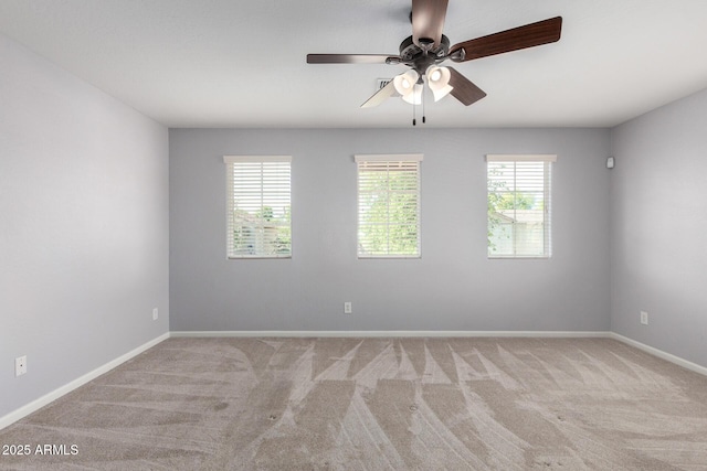 empty room featuring carpet floors, ceiling fan, and baseboards