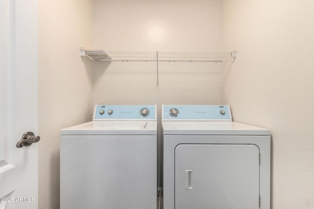 washroom with washing machine and clothes dryer
