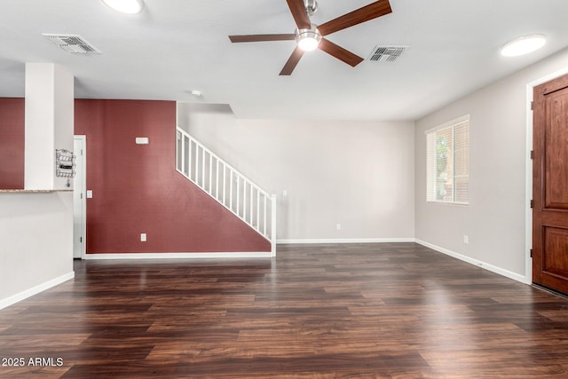 unfurnished living room with ceiling fan, stairs, wood finished floors, and baseboards