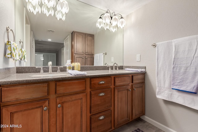 bathroom featuring vanity, a chandelier, and tile patterned floors